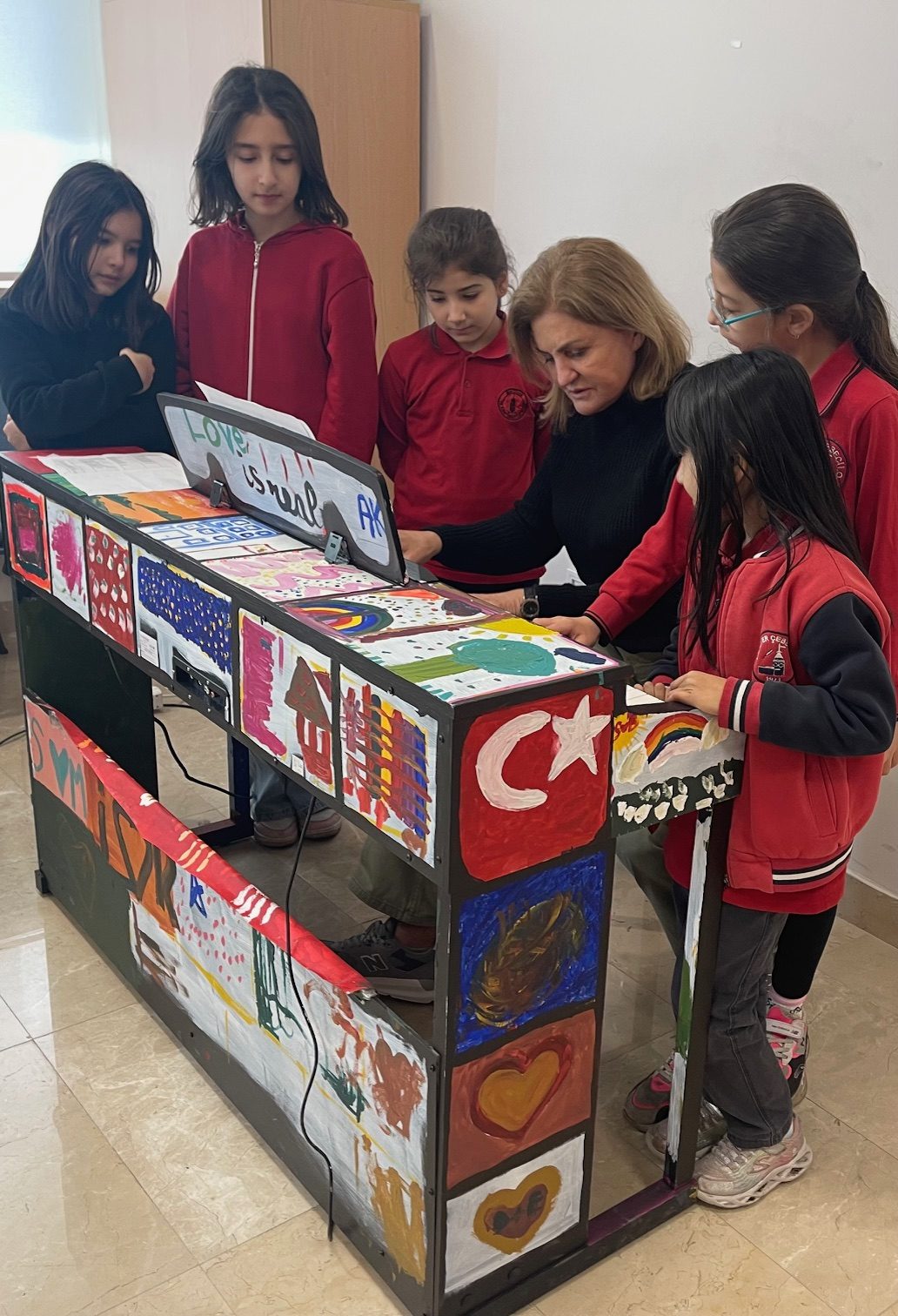 Students and their teachers at a painted piano